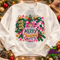 Pink and green Merry Christmas ornament design shown on a light crewneck; watermarked Wickedly Crafted mockup